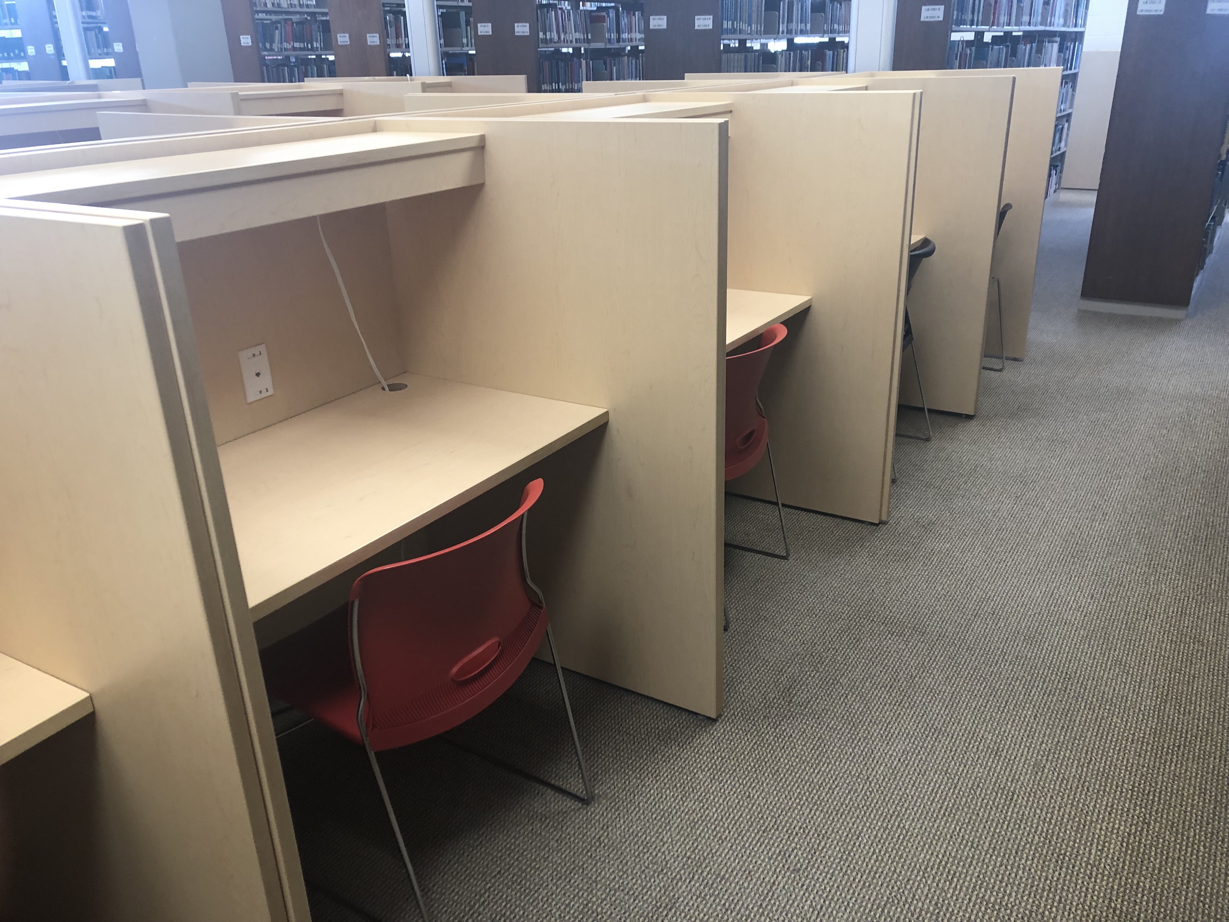 A row of study carrels. Desks side by side with privacy partition between them. Not much space under the desk for a guide dog. Dimensions are in text on this page
