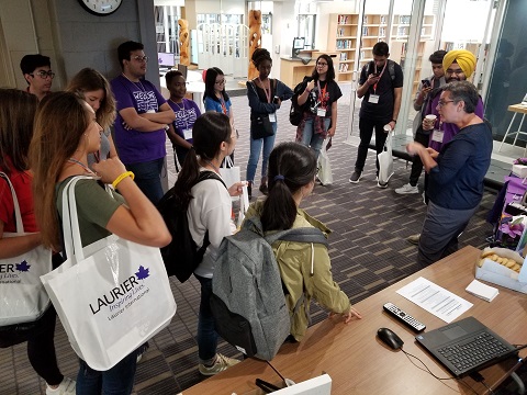 A group of students in the Waterloo campus library listening to a librarian