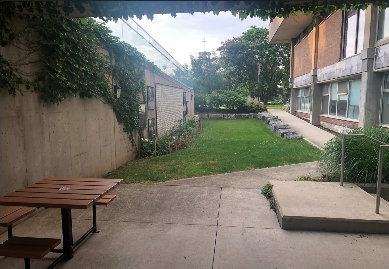 View from sunken garden under the entrance bridge. Tables with a spot for a wheelchair