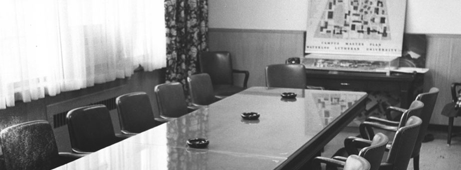 Board room with long table with ten chairs.