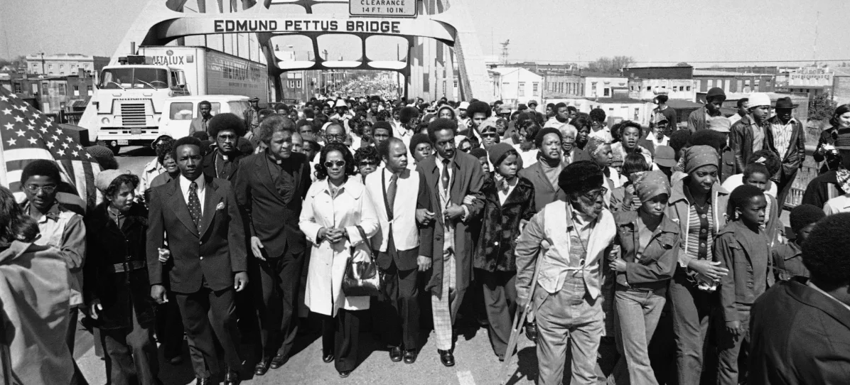 A group of approximately 5000 African Americans march across the Edmund Pettus Bridge.