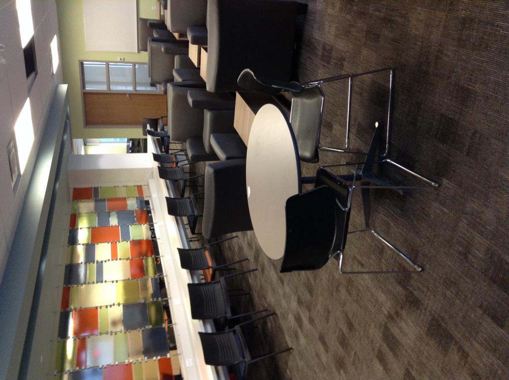 part of large space. Carpeted floors. A row of chairs along a very long table in the middle of the room. Comfy chairs also in the middle and a table. I&apos;m sure a dog could rest well here. An unlabeled door of a librarian&apos;s office. Contact Irene Tencinger for more description, i t e n c i n g e r @ w l u dot c a