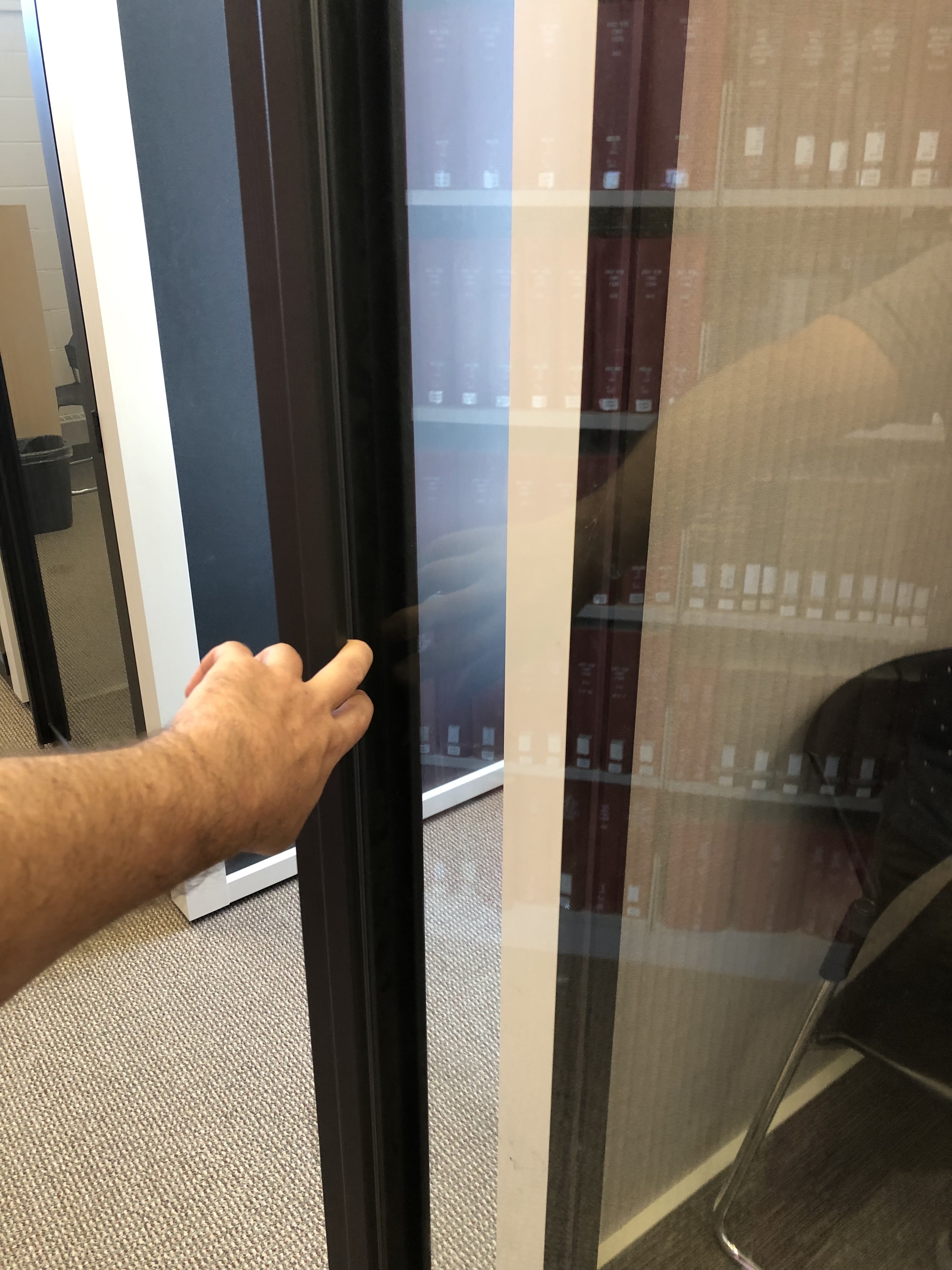 A photo of a hand opening the glass door with two fingers. Description of pods follows at heading 2