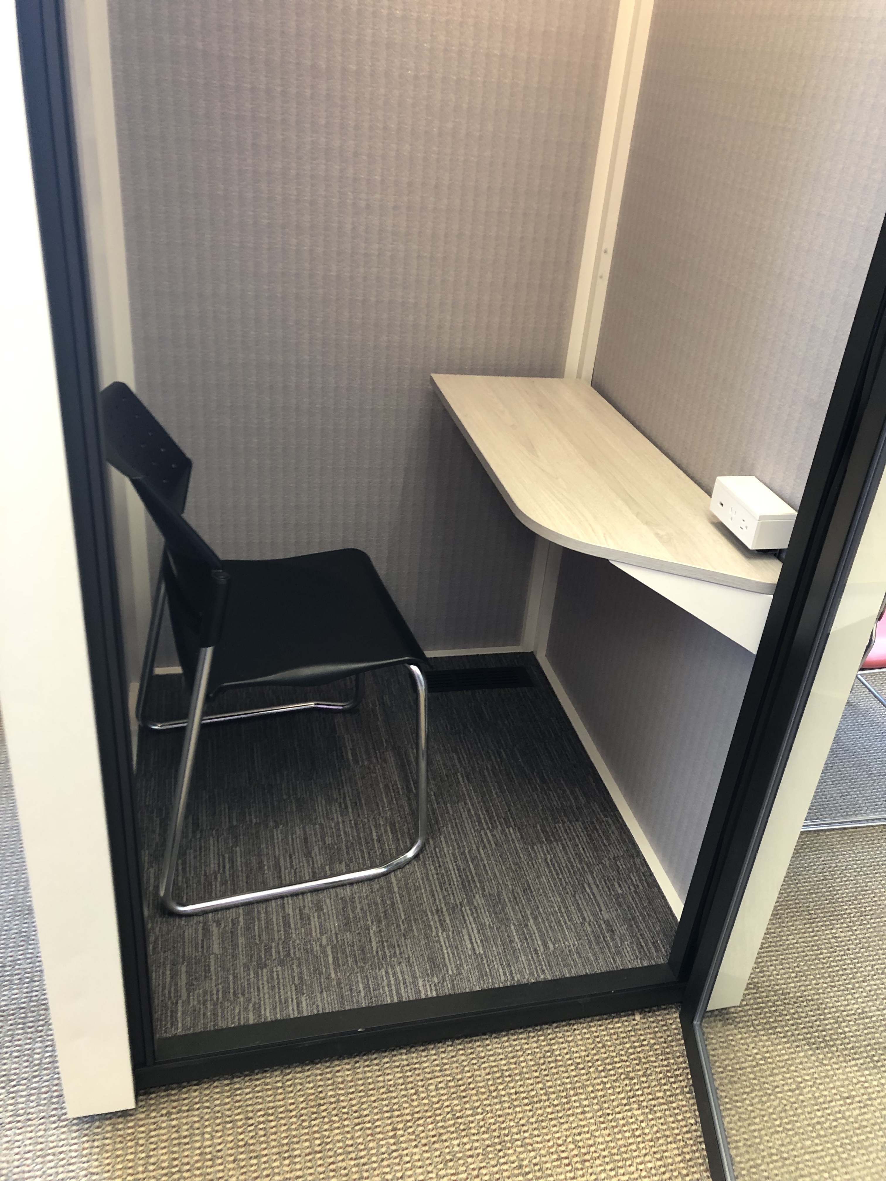 Photo of study pod showing chair, desk, and a step from floor to interior. Description of pods follows at heading 2