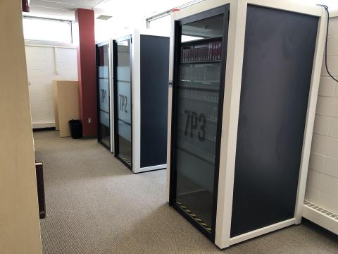 Study pods are enclosed spaces, like a phone booth. It seats one person and there is a surface for a laptop.