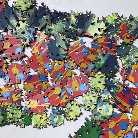 Flat, pointed shapes of similar size and form, scattered across a surface