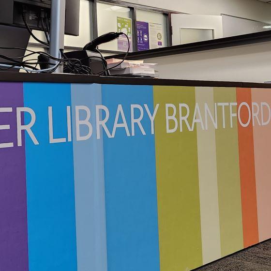 A desk to serve users, labelled Library Brantford